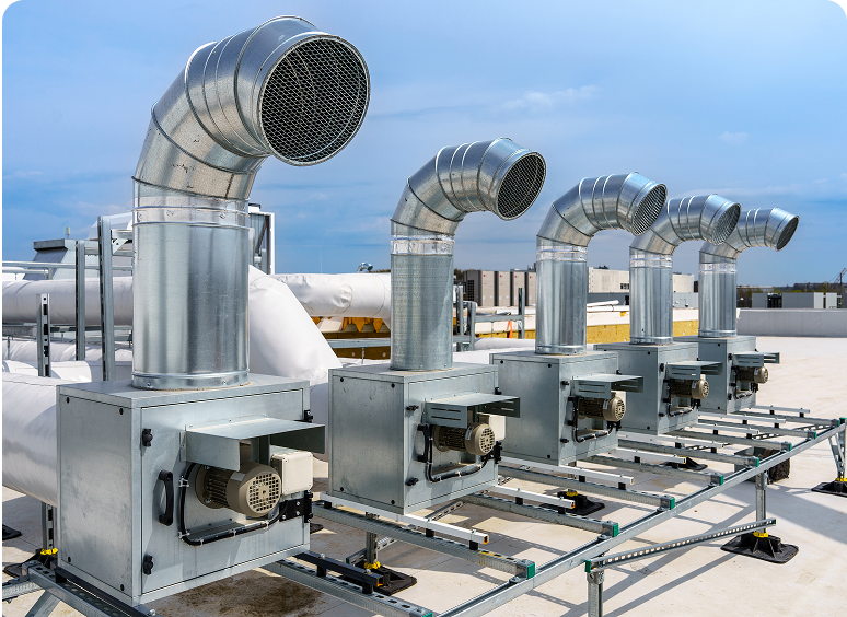 Four industrial ventilation systems on rooftop.