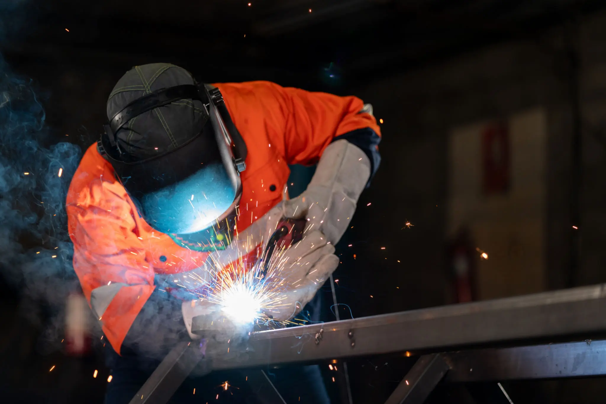 Welder working with bright sparks flying.